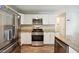 Modern kitchen with stainless steel appliances and granite countertops at 93 Carriage Lake Dr, Stockbridge, GA 30281