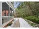 Backyard view features a tranquil screened porch with lush greenery and a walkway at 2355 Henderson Mill Ne Rd # 6, Atlanta, GA 30345