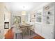 Open dining area with modern lighting, built-in shelving, and access to the outdoor deck at 2355 Henderson Mill Ne Rd # 6, Atlanta, GA 30345