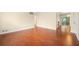 Hardwood floors gleam in the sunlight in this empty living room space at 2355 Henderson Mill Ne Rd # 6, Atlanta, GA 30345