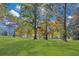 Open lawn area with tall trees; fall foliage colors at 1445 Hillside Dr, Grayson, GA 30017