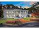 Elegant white mansion with columns, brick walkway, and manicured lawn at 1445 Hillside Dr, Grayson, GA 30017