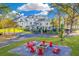 Red chairs around a fire pit in a landscaped backyard at 1445 Hillside Dr, Grayson, GA 30017