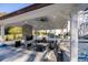 Outdoor kitchen and dining area with fireplace and ceiling fan at 1445 Hillside Dr, Grayson, GA 30017