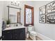 Charming powder room with stained glass window and dark vanity at 1445 Hillside Dr, Grayson, GA 30017