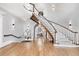 Elegant curved staircase with white railings and hardwood floors at 1445 Hillside Dr, Grayson, GA 30017