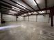 Large, bright workshop with high ceilings and concrete flooring at 1445 Hillside Dr, Grayson, GA 30017