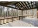 Large back porch with wooden railing overlooking a beautiful wooded landscape at 2468 Ridgeway Dr, Atlanta, GA 30360