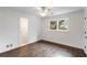 Bedroom featuring hardwood floors, white walls, ceiling trim, and a window with natural light at 2468 Ridgeway Dr, Atlanta, GA 30360