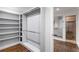 Walk-in closet featuring built-in shelving and hanging space, leading to a renovated bathroom at 2468 Ridgeway Dr, Atlanta, GA 30360