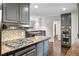 Modern kitchen featuring stainless steel appliances, gray cabinetry, and granite countertops at 2468 Ridgeway Dr, Atlanta, GA 30360