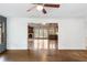 Elegant living room view with hardwood floors featuring stone fireplace and wet bar in dining area at 2468 Ridgeway Dr, Atlanta, GA 30360