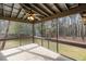 Screened porch with ceiling fan and view of treed backyard at 2468 Ridgeway Dr, Atlanta, GA 30360