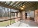 Spacious screened porch that offers views of a brick house and wooded landscape at 2468 Ridgeway Dr, Atlanta, GA 30360