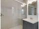 Modern bathroom with gray vanity and herringbone tile floor at 2488 Elizabeth Ann Ne Ln, Atlanta, GA 30324