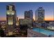 Luxury high-rise building with a rooftop pool and city skyline view at 3324 Peachtree Ne Rd # 1114, Atlanta, GA 30326