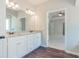 Modern bathroom featuring a double vanity, granite countertop, and wood-look flooring at 459 Benson Meadows Dr, Dallas, GA 30157