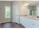 Elegant bathroom with double vanity, granite countertop, and dark wood flooring at 459 Benson Meadows Dr, Dallas, GA 30157