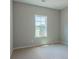 Neutral bedroom with soft carpet, light gray walls, and a bright window at 459 Benson Meadows Dr, Dallas, GA 30157