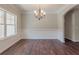 Elegant dining room with dark wood floors, chandelier, and decorative wainscoting at 459 Benson Meadows Dr, Dallas, GA 30157