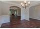 Dining room with dark wood floors, arched doorways, and a view into the living room at 459 Benson Meadows Dr, Dallas, GA 30157