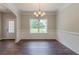 Formal dining area featuring dark floors, chandelier and view to outside at 459 Benson Meadows Dr, Dallas, GA 30157