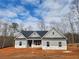 New construction with gray siding, a dark roof, and a simple, elegant design at 459 Benson Meadows Dr, Dallas, GA 30157