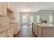 Bright kitchen featuring granite counters, white cabinets, and modern fixtures, seamlessly connected to the living area at 459 Benson Meadows Dr, Dallas, GA 30157