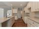 Modern kitchen with granite counters, island and stainless steel sink at 459 Benson Meadows Dr, Dallas, GA 30157