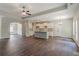 Spacious living room featuring dark wood floors, white cabinets, granite countertops, and modern lighting at 459 Benson Meadows Dr, Dallas, GA 30157