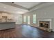 Spacious living room with fireplace, hardwood floors, and an open-concept design to the kitchen at 459 Benson Meadows Dr, Dallas, GA 30157