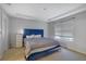 Bedroom featuring a bed with a blue headboard, a window and a white dresser with storage at 533 Bentley Pl, Tucker, GA 30084