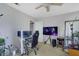 Bright room featuring desk with monitors, gaming chair and a large TV, illuminated by lights and natural light at 533 Bentley Pl, Tucker, GA 30084