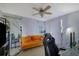 Bedroom featuring an orange couch, plants, and large lights, creating a comfortable workspace at 533 Bentley Pl, Tucker, GA 30084