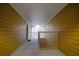 Building hallway with yellow siding, leading to a stairwell with a railing and a light at the end of the hall at 533 Bentley Pl, Tucker, GA 30084