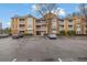 View of the apartment building exterior showing balconies, parking, and stone accents at 533 Bentley Pl, Tucker, GA 30084