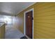 Exterior hallway of a building featuring a dark wooden door, leading to indoor units at 533 Bentley Pl, Tucker, GA 30084