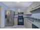 Bright kitchen with stainless steel appliances, ample counter space, and neutral-toned cabinets at 533 Bentley Pl, Tucker, GA 30084