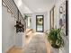 Light-filled entryway, hardwood floors, and modern staircase with metal railing at 200 Simonton Rd, Lawrenceville, GA 30046