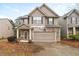 Two-story house with stone accents and a two-car garage at 4860 Longview Run, Decatur, GA 30035