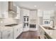 White kitchen with stainless steel appliances and herringbone backsplash at 6850 Canyon Creek Way, Cumming, GA 30028