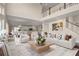 Open living room with hardwood floors, high ceilings, and a view of the kitchen at 6850 Canyon Creek Way, Cumming, GA 30028