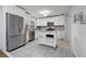 Modern kitchen with white cabinets, stainless steel appliances, and tile flooring at 785 Mckenzie Sw Ct, Atlanta, GA 30311