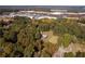 Aerial view of wooded lot near commercial center and homes at 157 New Hope Rd, Fayetteville, GA 30214
