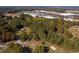 Aerial view of wooded lot with nearby homes and road at 157 New Hope Rd, Fayetteville, GA 30214