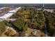 Aerial view showing home nestled in wooded area near shopping center at 157 New Hope Rd, Fayetteville, GA 30214