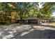 Brick ranch home with carport, covered patio, and mature trees at 157 New Hope Rd, Fayetteville, GA 30214