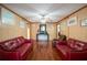 Living room with hardwood floors and red leather couches at 157 New Hope Rd, Fayetteville, GA 30214