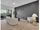 Gathering room with a dark accent wall, hardwood floors, and plenty of natural light at 332 Sugarview Rd # 16, Sugar Hill, GA 30518