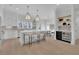 Open concept kitchen features an island, wine fridge, and breakfast bar at 332 Sugarview Rd # 16, Sugar Hill, GA 30518